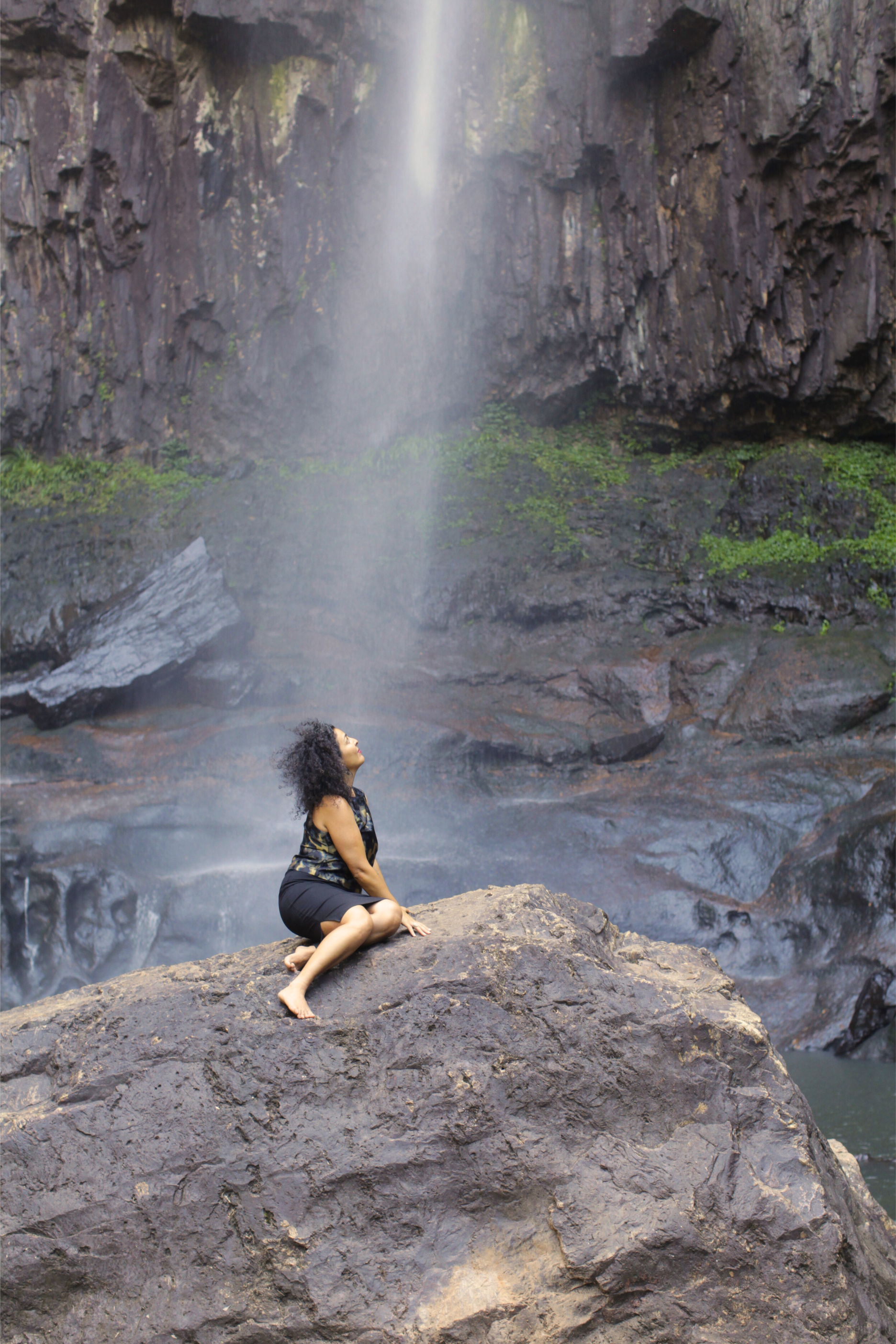 Woman in nature looking at a waterfall