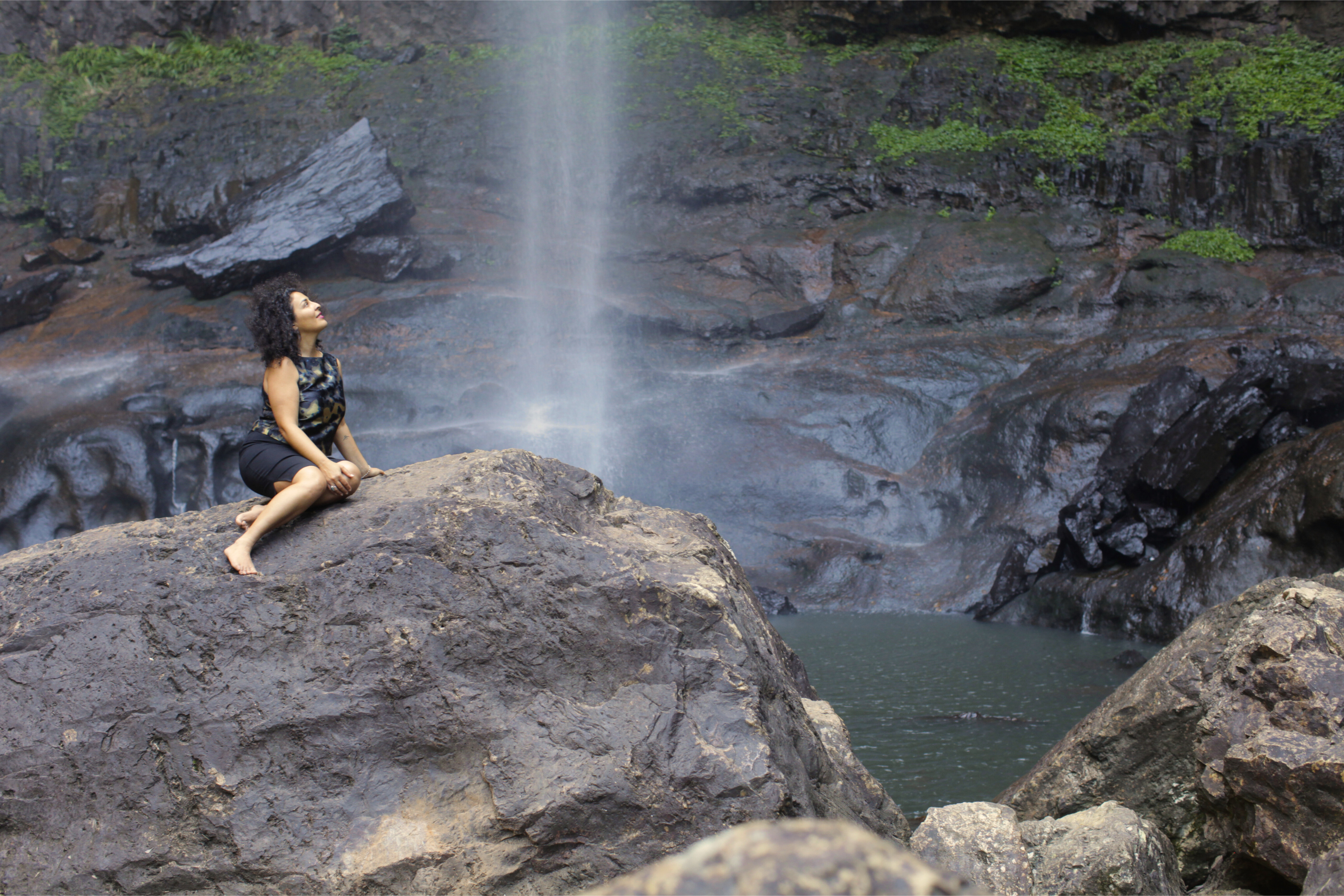 Woman in nature looking at waterfall