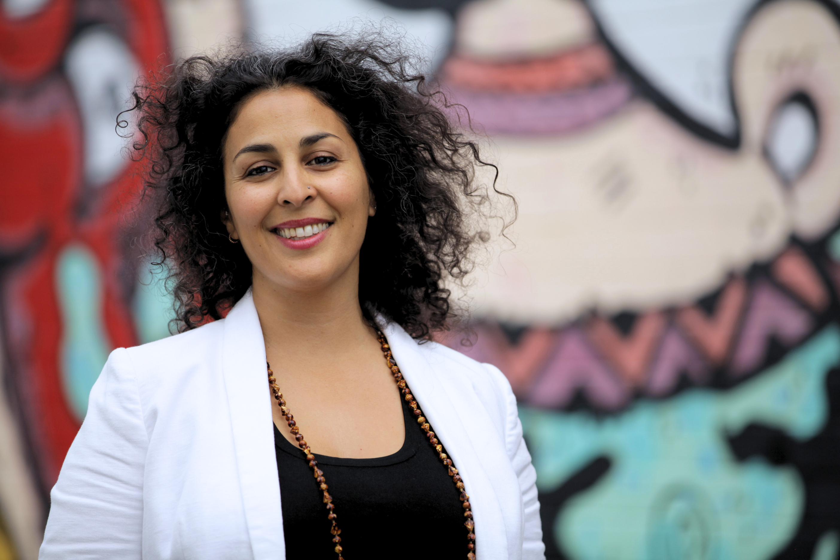 Woman smiling with graffiti background