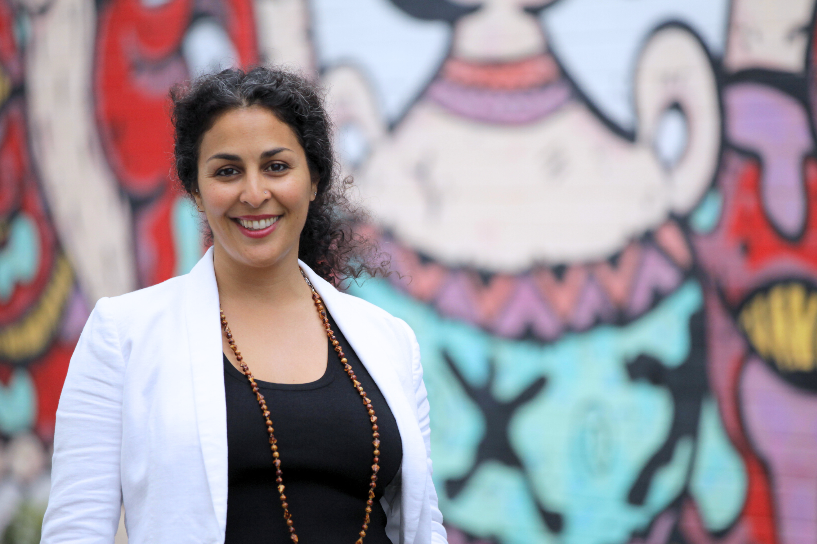 Woman smiling with graffiti background