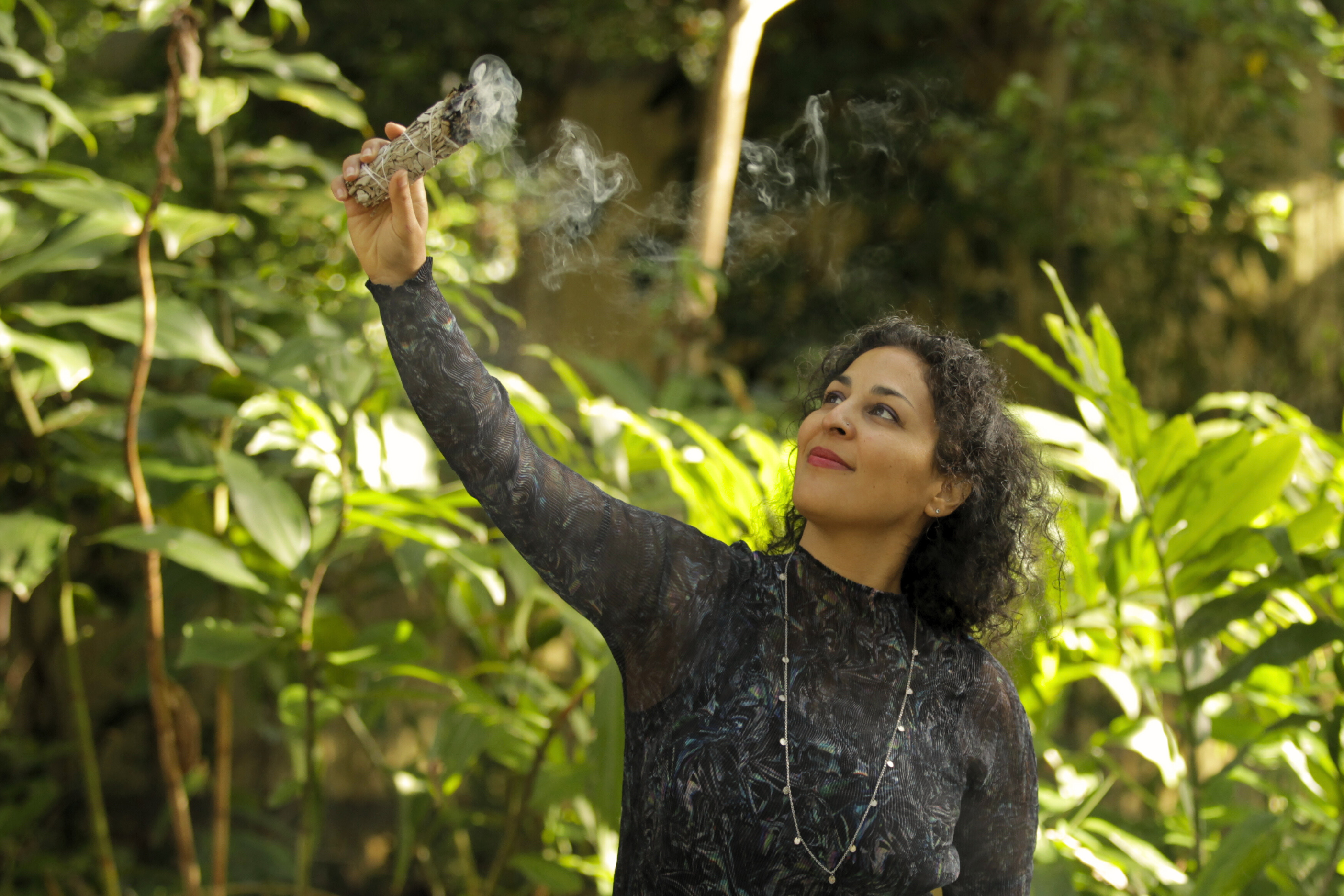 Woman standing in with sage