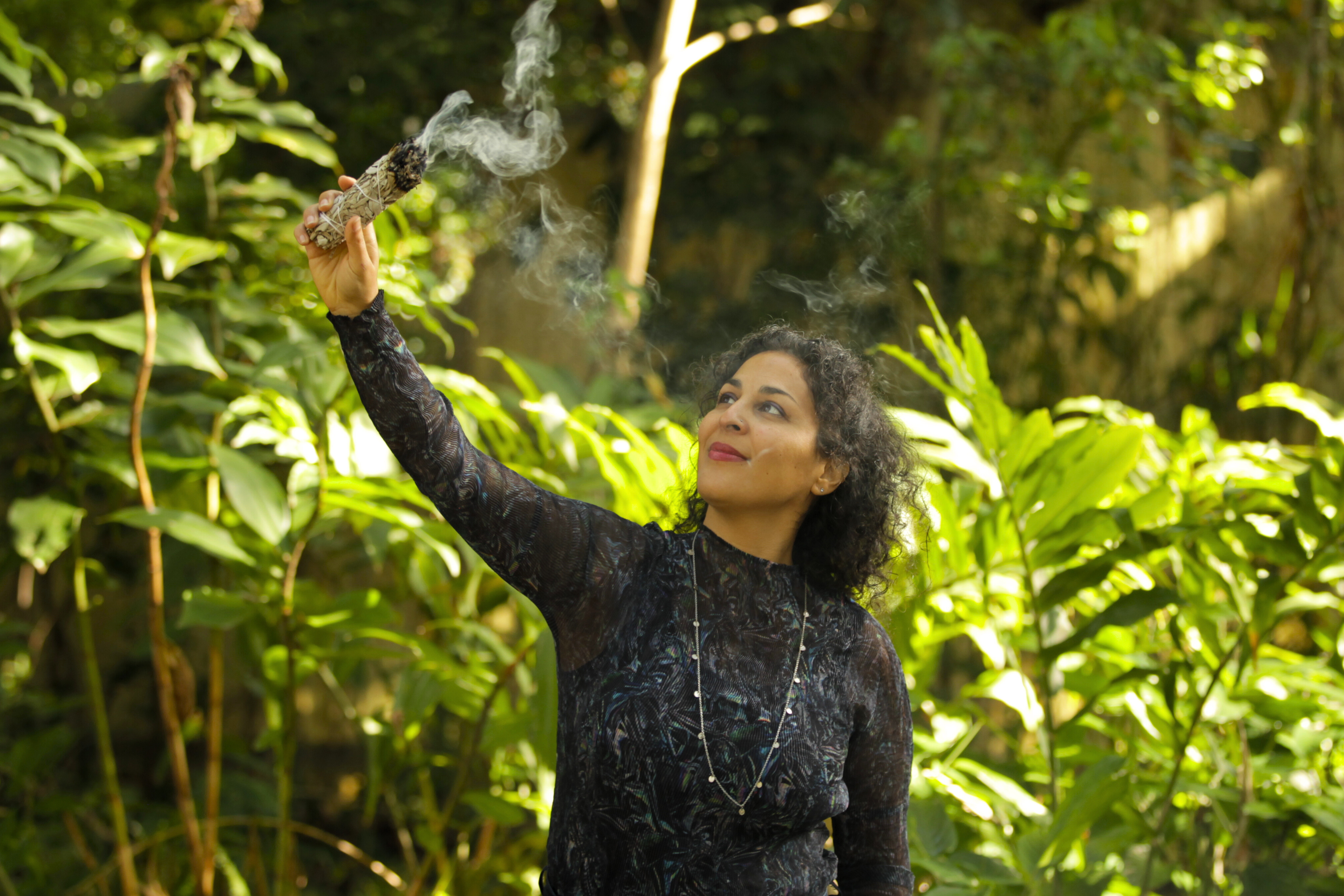 Woman burning sage during a sacred ceremony